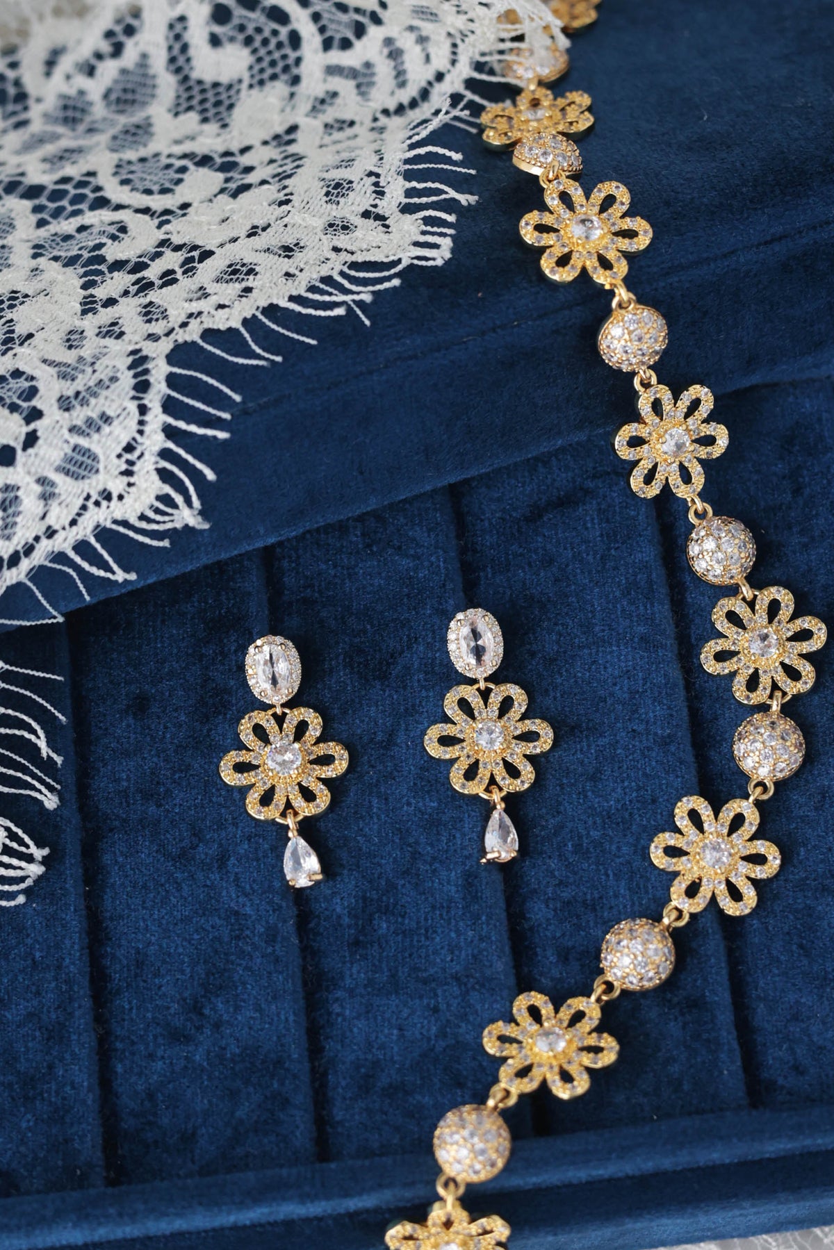 earrings ins golden metal with zirconia with matching choker in velvet blue box