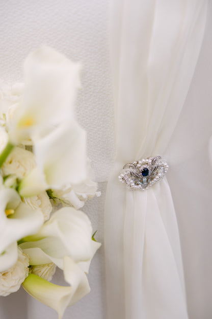 brooch holding a wedding dress