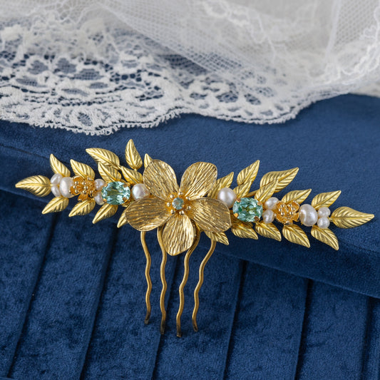 Gold floral hair comb with pearls and gemstones on a blue velvet box with lace background
