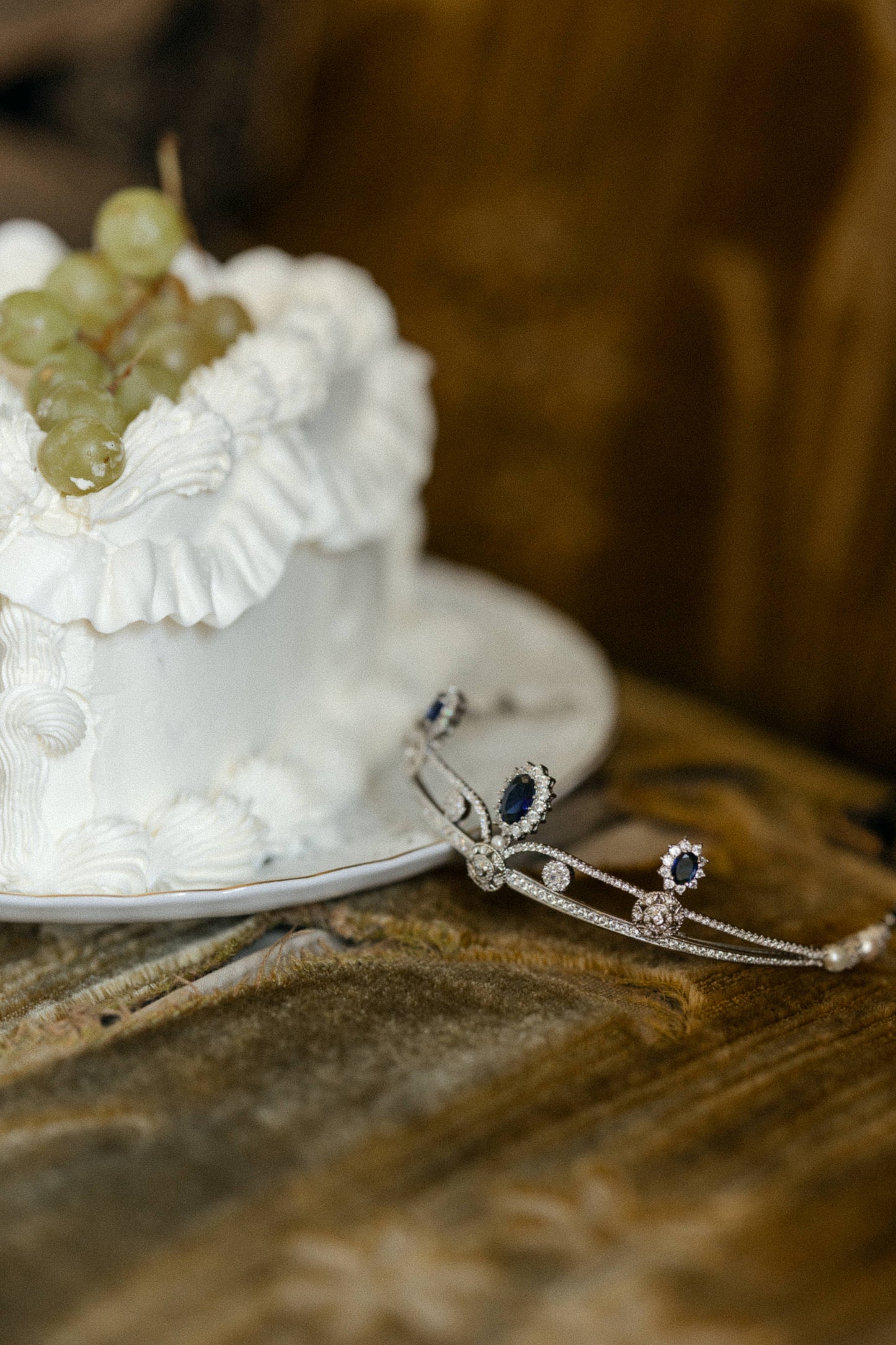 odette tiara in silver and sapphire color crystals with a wedding cake