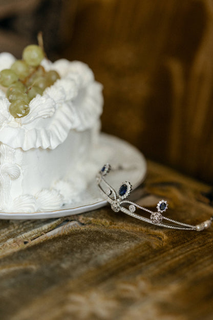 odette tiara in silver and sapphire color crystals with a wedding cake