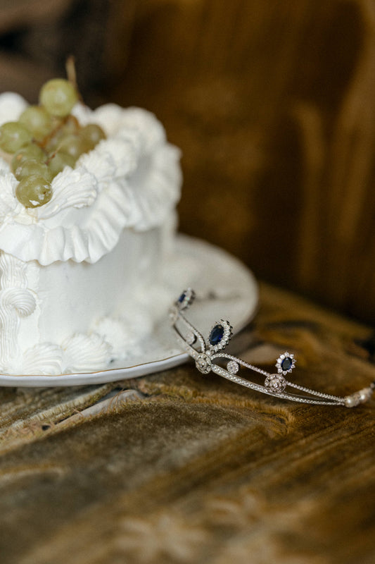 odette tiara in silver and sapphire color crystals with a wedding cake